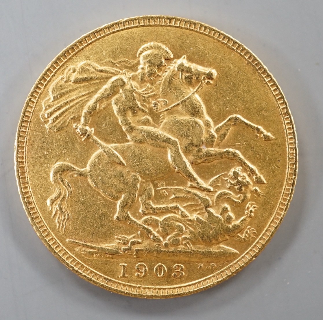An Edward VII 1903 gold sovereign.